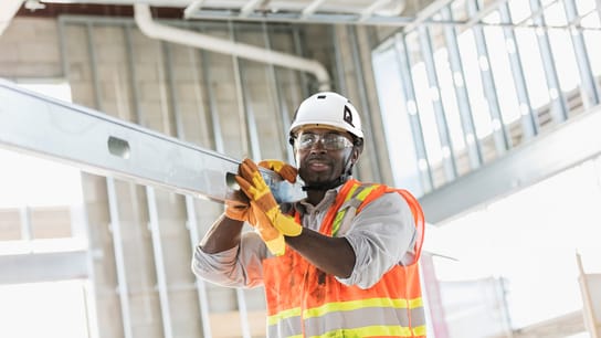 Man working carrying beam