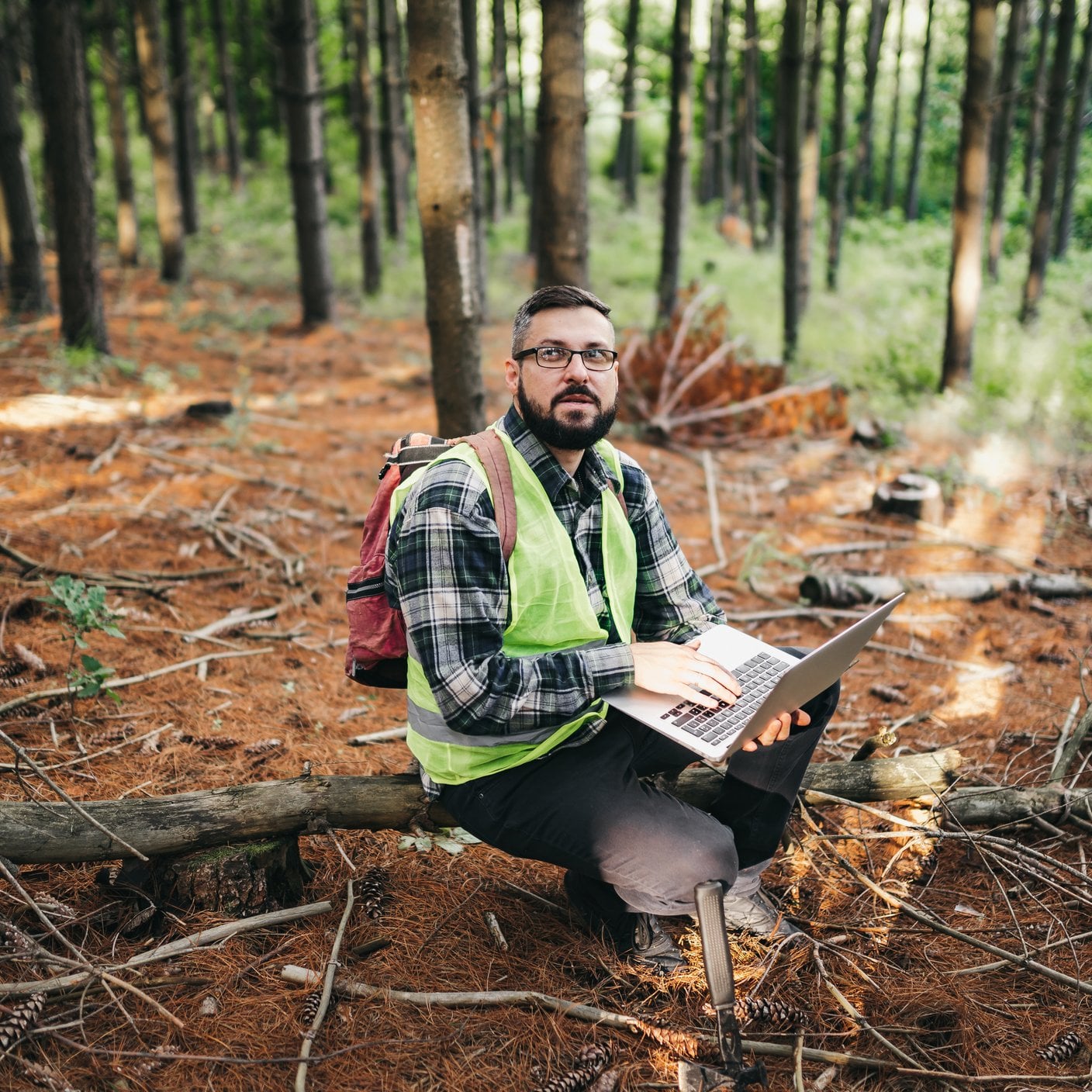 Man in the forest in work gear.