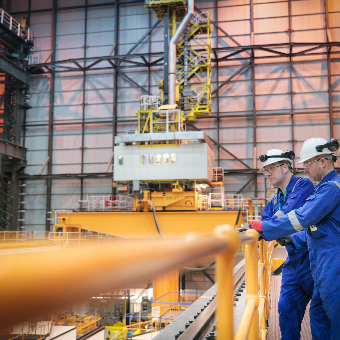 Engineers inspecting reactor hall in nuclear power station.