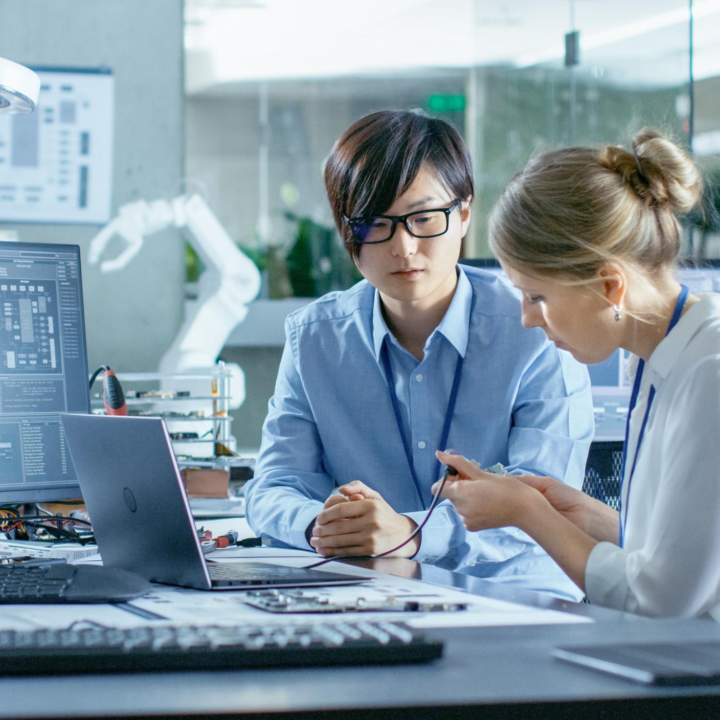 Two computer scientists carrying out information security management system testing