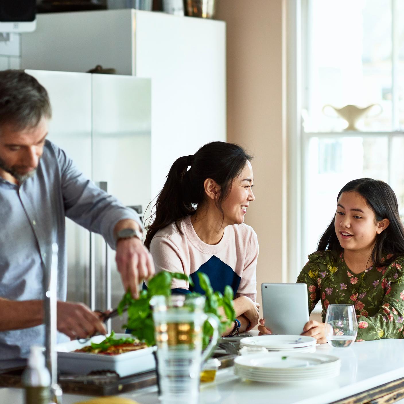 Relaxed multi racial family at home, cooking family meal
