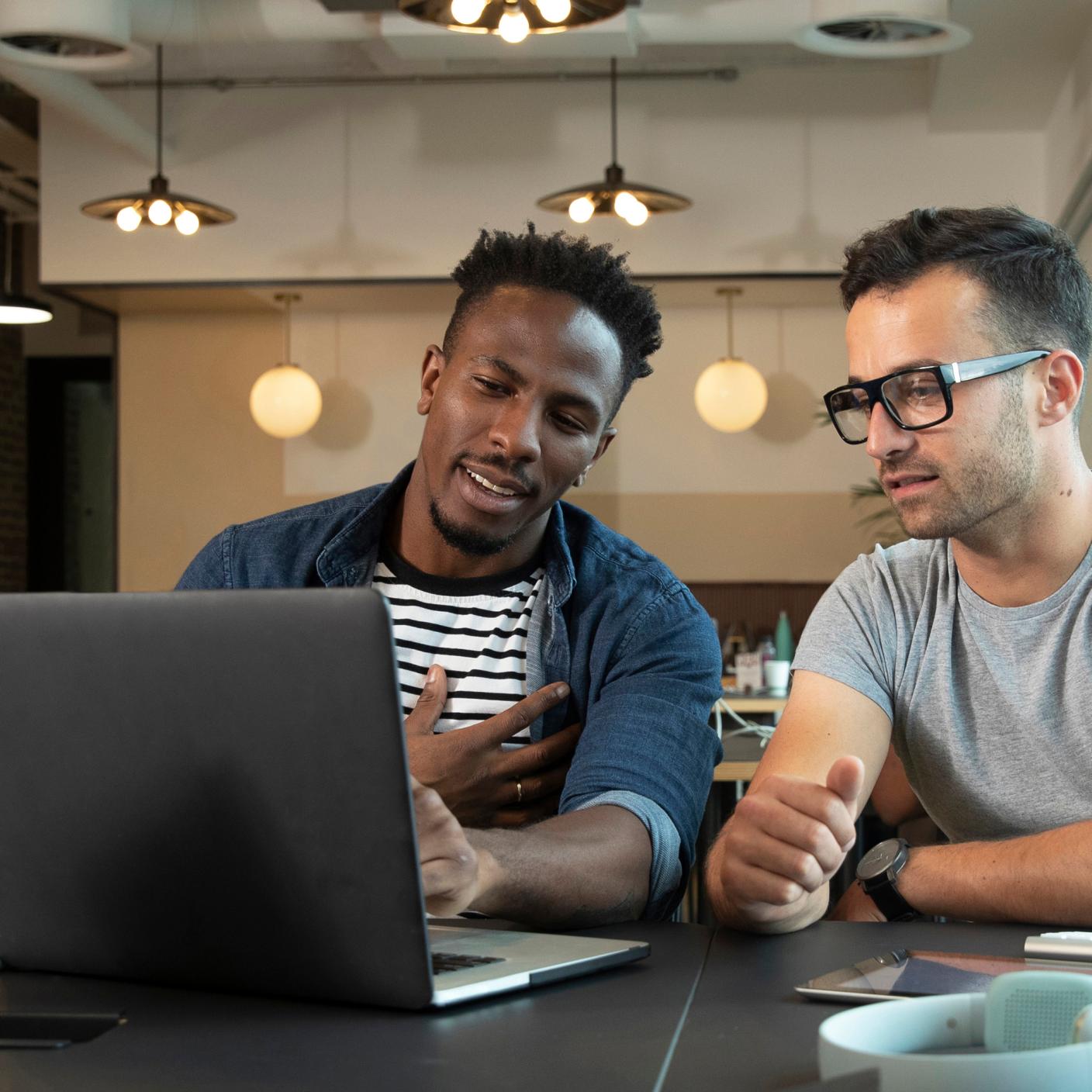 two men looking at laptop