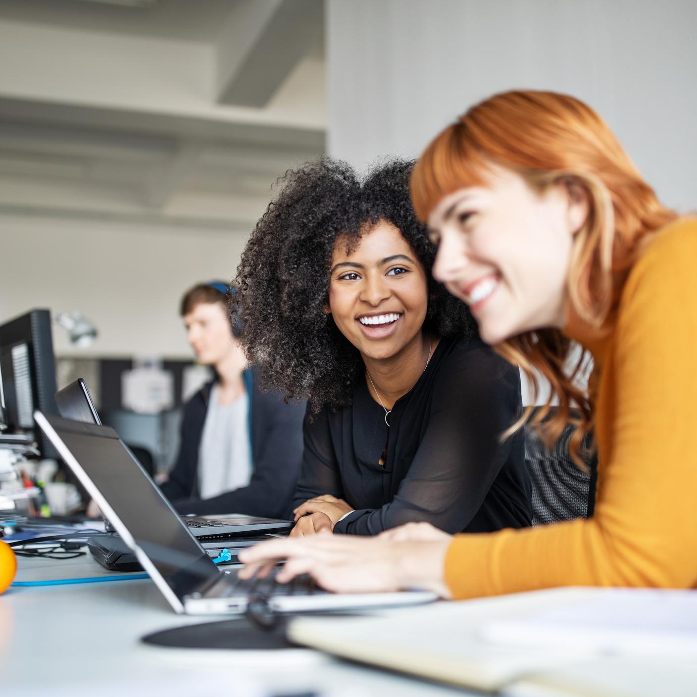 two women looking at a lap top