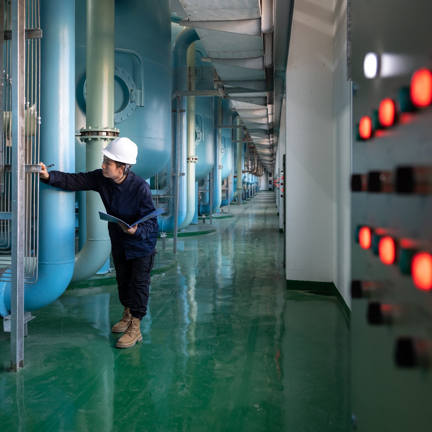 A female safety officer works in a chemical plant