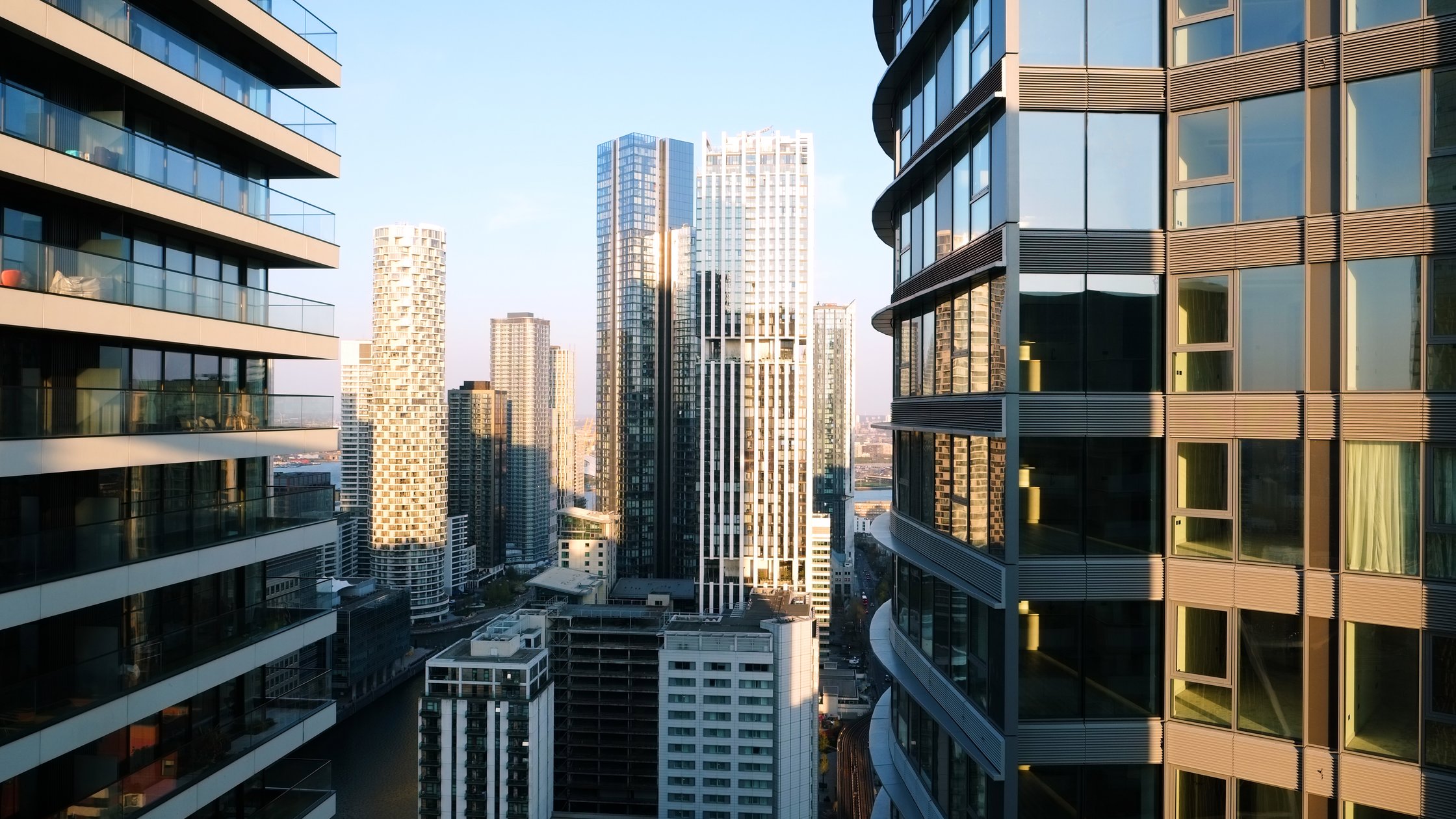 UK, London, Canary Wharf, elevated view over city skyline in Canary Wharf illuminated at sunset.