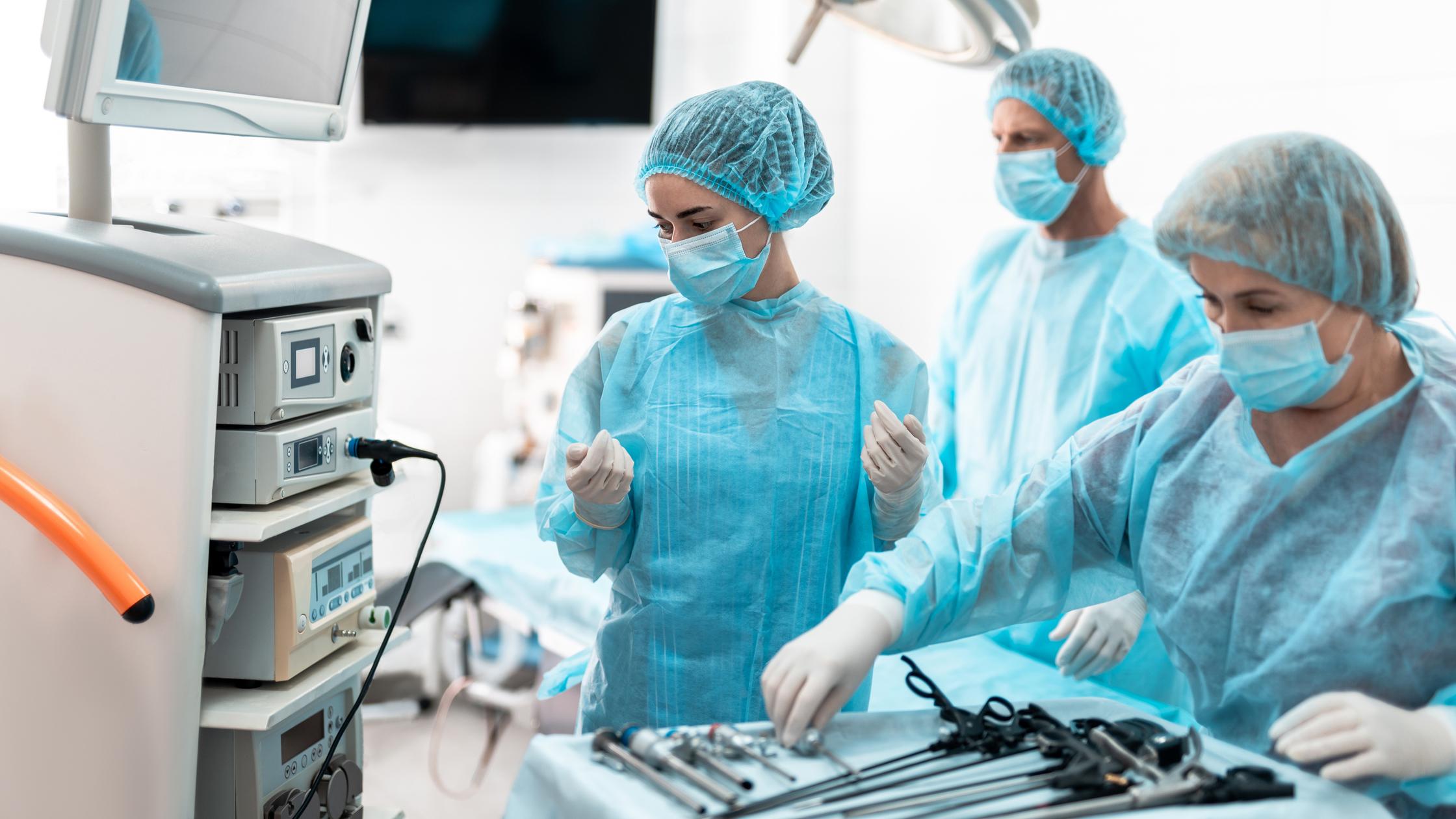 Waist up portrait of nurses in protective masks and sterile gloves