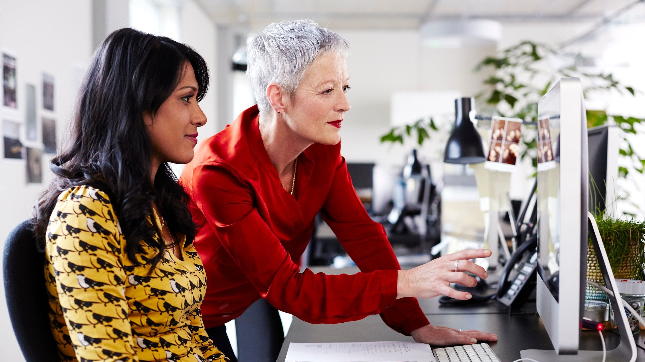 Mature business woman mentoring younger employee