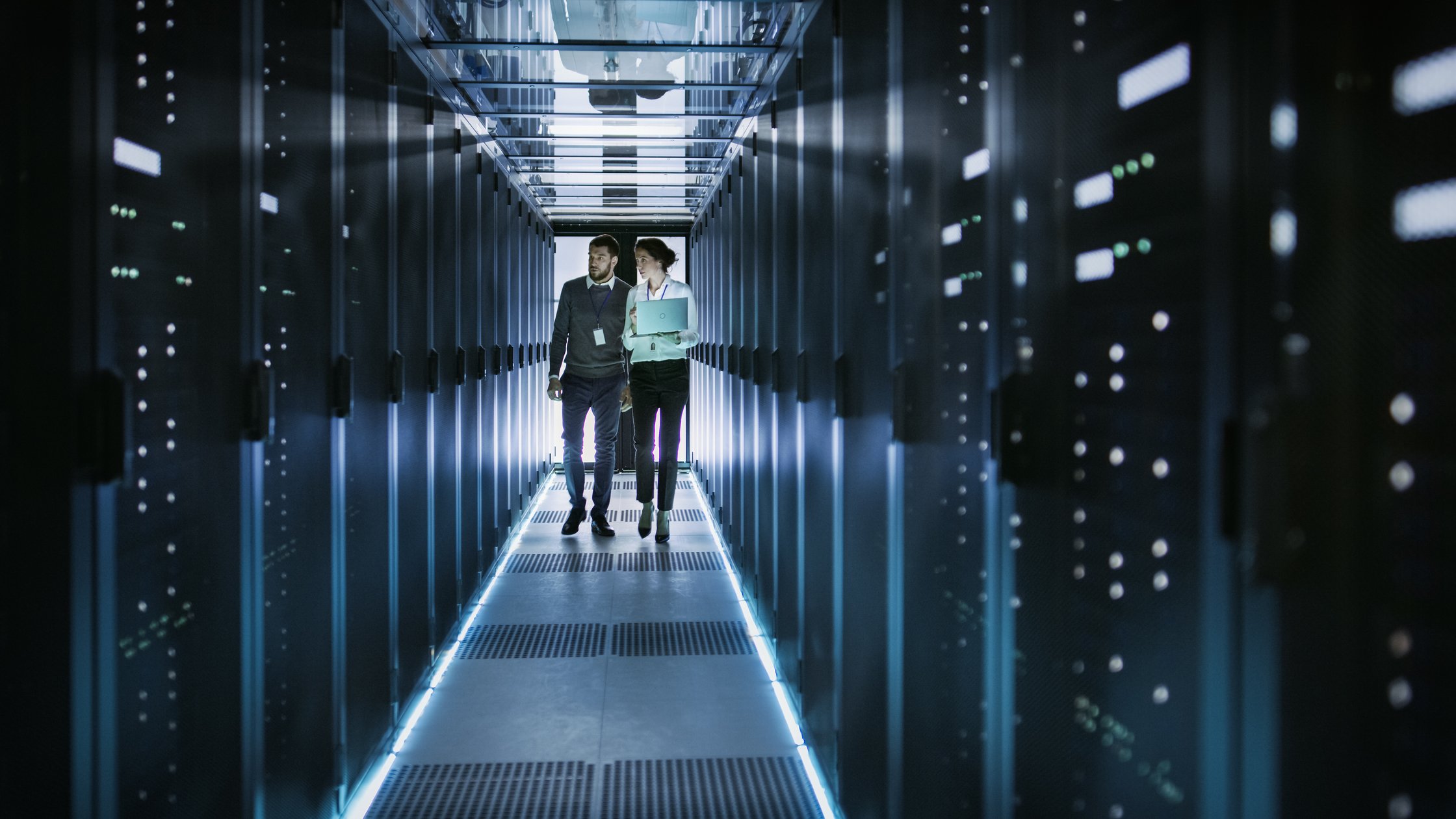 People in data centre reviewing racks